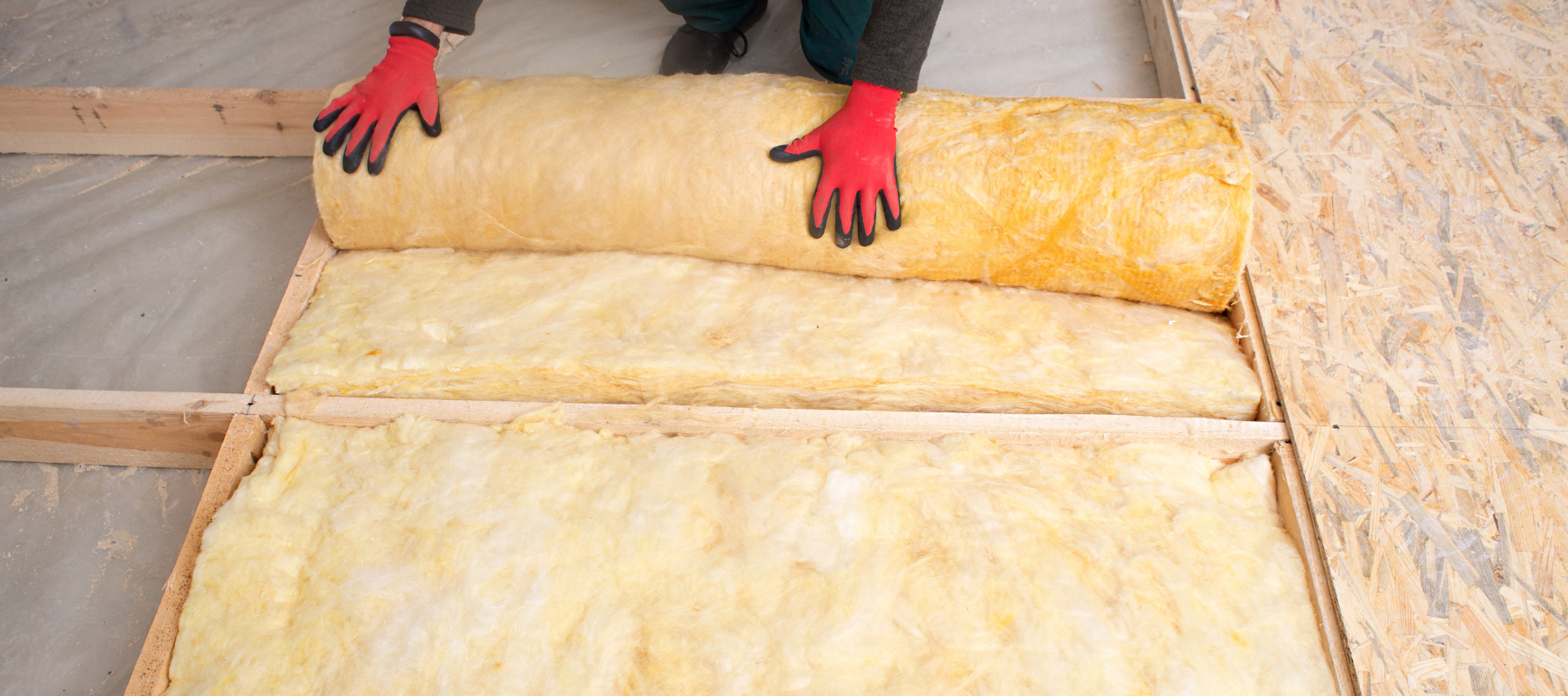 Yellow insulation being rolled out and installed to a floor